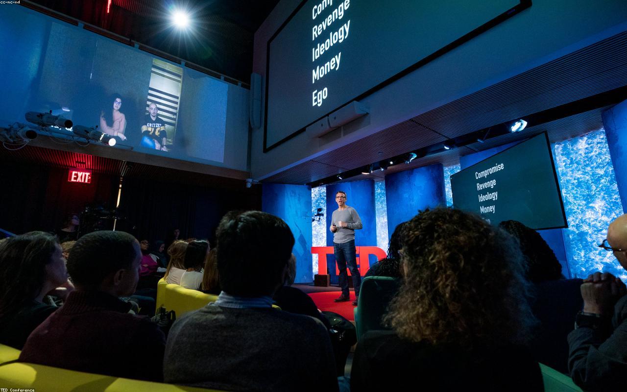 A professional male keynote speaker addressing a business audience